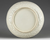 A Chinese white-glazed moulded ‘dragon’ dish