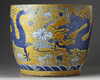 A large Chinese yellow-ground blue and white ‘dragons’ jardinière