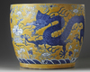 A large Chinese yellow-ground blue and white ‘dragons’ jardinière