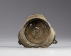 An Islamic bronze lamp stand