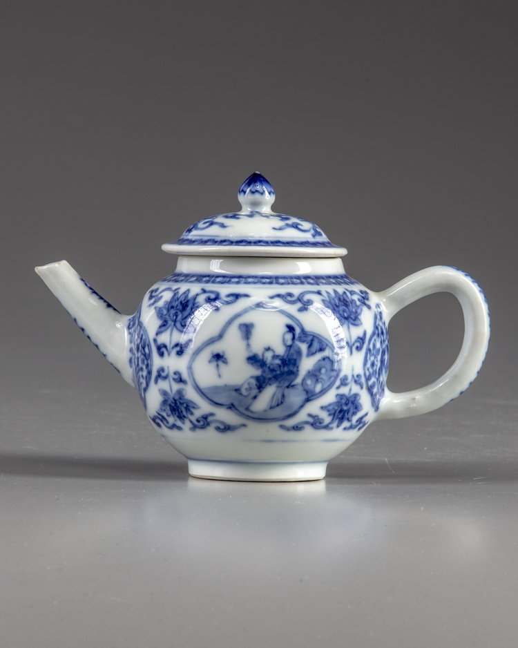 A blue and white teapot and cover