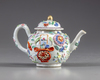 A Chinese famille rose moulded teapot and cover