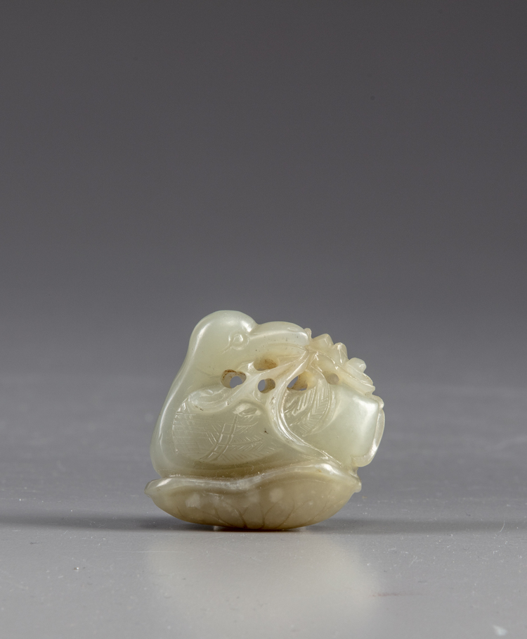 A Chinese celadon jade 'duck and lotus' carving