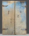 Two carved wooden window shutters