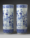 A pair of large blue and white umbrella stands