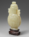 A Chinese pale celadon jade 'taotie' vase and cover