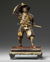 A Japanese parcel gilt bronze figure of a Samurai