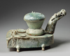 A CHINESE GREEN-GLAZED POTTERY STOVE WITH A DRAGON CHIMNEY