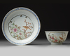A Chinese famille rose ‘bird and flower’ cup and saucer