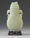A Chinese pale celadon jade vase and cover