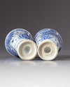 Two blue and white stemmed beakers