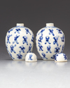 A pair of small blue and white 'boys' jars with covers