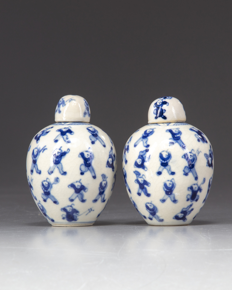 A pair of small blue and white 'boys' jars with covers