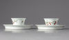 A pair of Chinese famille verte cups and saucers