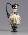 A Roman trefoil lipped purple glass jug