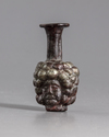 A ROMAN PURPLE GLASS HEAD FLASK, CIRCA 3RD CENTURY AD