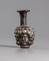 A ROMAN PURPLE GLASS HEAD FLASK, CIRCA 3RD CENTURY AD