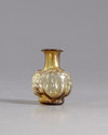 A ROMAN HEAD GLASS FLASK, CIRCA 3RD CENTURY AD
