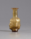 A ROMAN HEAD GLASS FLASK , CIRCA 3RD CENTURY AD
