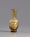 A ROMAN HEAD GLASS FLASK , CIRCA 3RD CENTURY AD