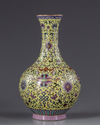 A Chinese yellow-ground famille rose bottle vase