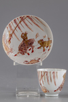 A gilt Chinese cup and saucer