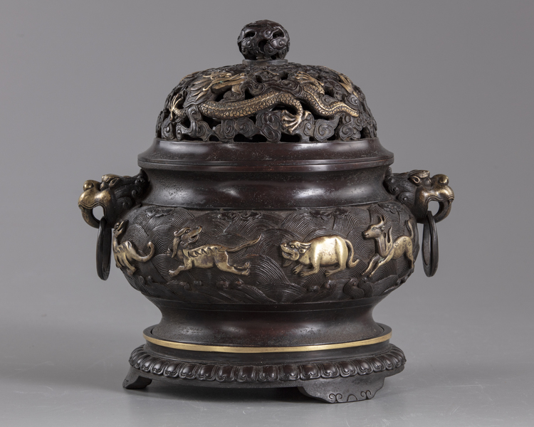A Chinese parcel-gilt bronze 'sea creatures' censer, cover, and stand