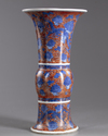 A Chinese iron-red-ground blue and white 'dragon and lotus' vase, gu