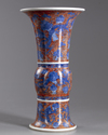 A Chinese iron-red-ground blue and white 'dragon and lotus' vase, gu