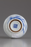 A blue and white circular paste box and cover