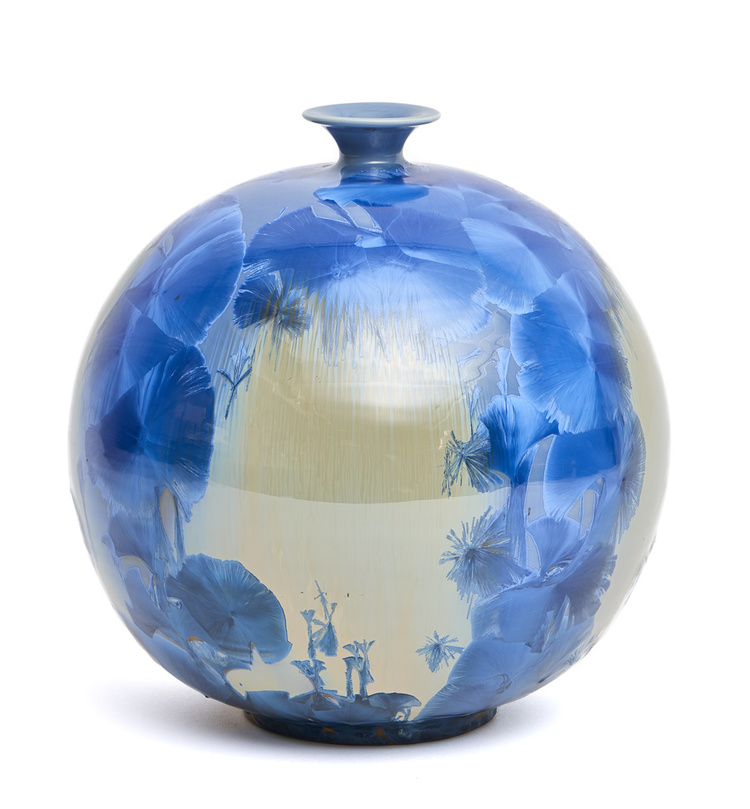 A Japanese globular vase with a narrow mouth decorated with metallic clear blue patches