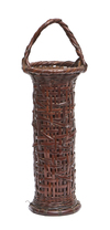 A tall and slender Japanese round wickerwork Ikebana flower basket with a fixed bamboo handle