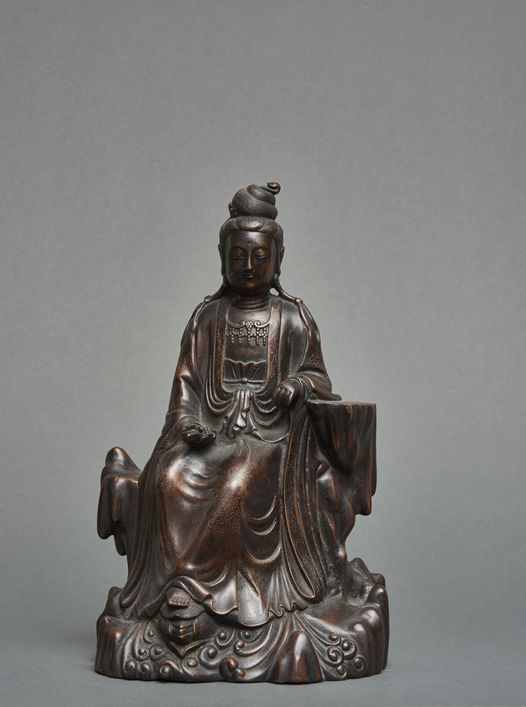 A Chinese silver-inlaid dark bronze figure of a bodhisattva Guanyin