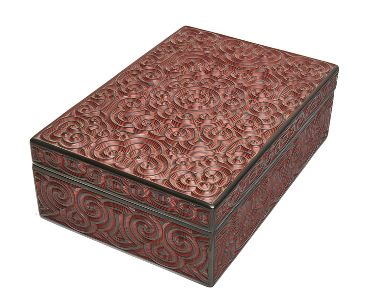A  Japanese lacquerwork box, its lid and sides decorated with carved arabesques