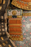 A large gilded Japanese ōyoroi with orange cords (hi’ito odoshi yoroi). A large hoshikabuto-helmet with gilded parts, large fukikaeshi