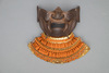 A large gilded Japanese ōyoroi with orange cords (hi’ito odoshi yoroi). A large hoshikabuto-helmet with gilded parts, large fukikaeshi