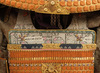 A large gilded Japanese ōyoroi with orange cords (hi’ito odoshi yoroi). A large hoshikabuto-helmet with gilded parts, large fukikaeshi