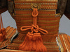 A large gilded Japanese ōyoroi with orange cords (hi’ito odoshi yoroi). A large hoshikabuto-helmet with gilded parts, large fukikaeshi