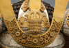 A large gilded Japanese ōyoroi with orange cords (hi’ito odoshi yoroi). A large hoshikabuto-helmet with gilded parts, large fukikaeshi