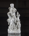 A CHINESE DEHUA GLAZED FIGURE OF GUANYIN AND A BOY, QING DYNASTY (1644-1911)