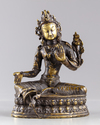 A Tibetan gilt bronze figure of the green Tara, Syamatara