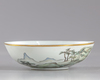 A Chinese Zhangzhou Swatow blue and white charger and a famille rose bowl
