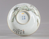 A Chinese Zhangzhou Swatow blue and white charger and a famille rose bowl