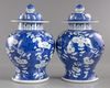 A pair of blue and white Chinese 'cherry blossom' vases and covers