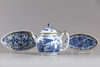 A Chinese blue and white teapot and two oval shaped trays