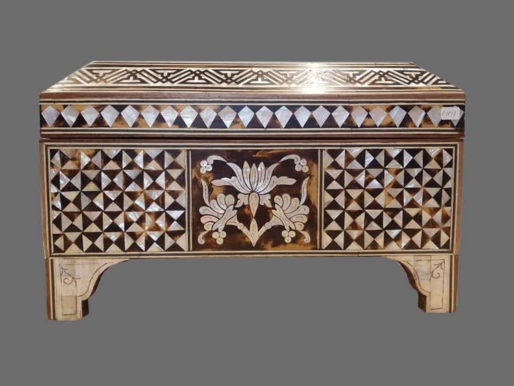 A wooden mother of pearl inlaid box