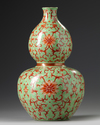 A Chinese lime green ground iron red decorated double gourd vase