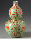 A Chinese lime green ground iron red decorated double gourd vase