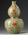 A Chinese lime green ground iron red decorated double gourd vase