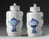 A pair of small Chinese blue and white vases and covers